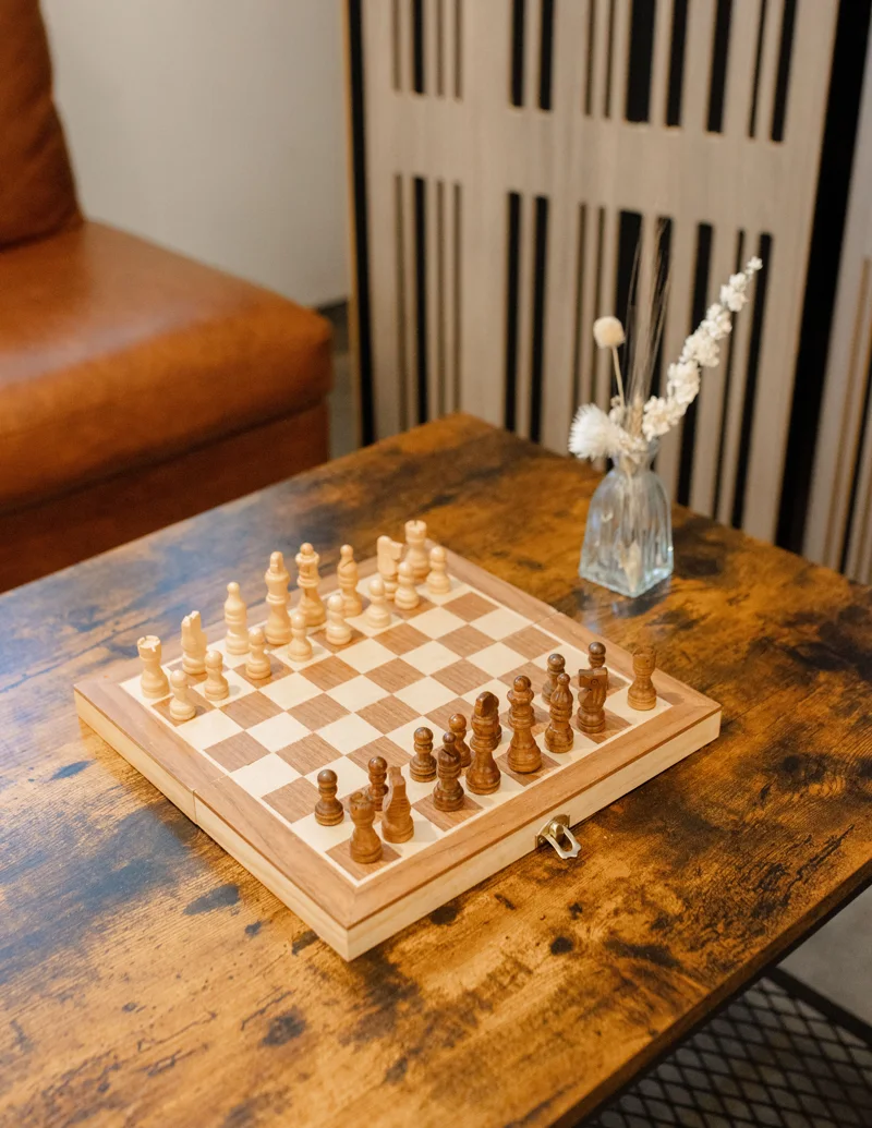 A chessboard ready for a game beside the café sofa