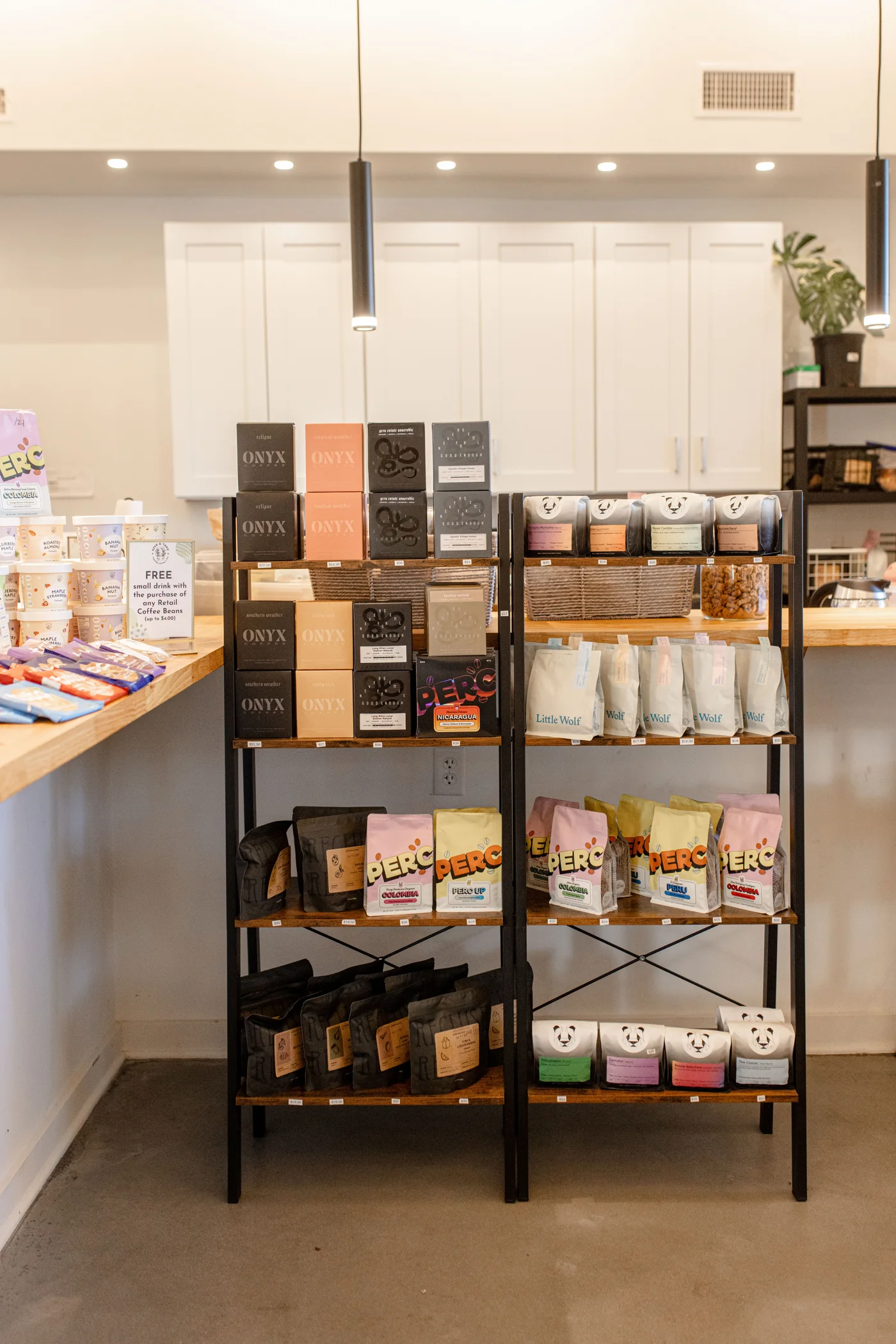 The retail coffee shelf beside Give & Take’s current bar