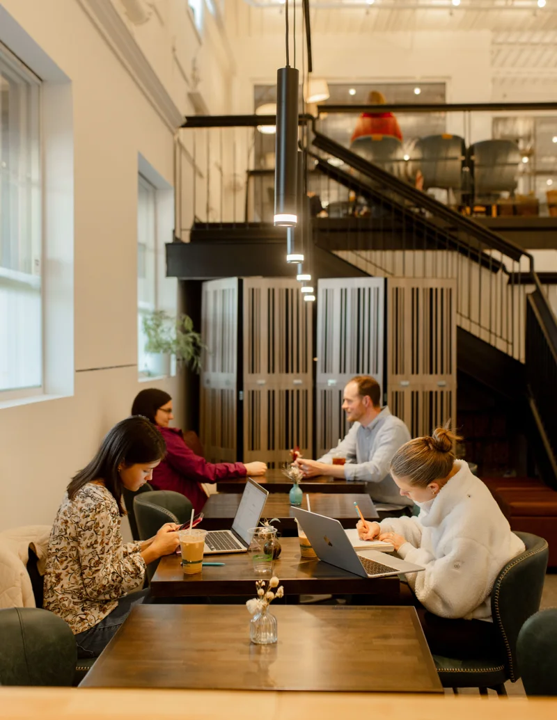 Guests talking over drinks at the café tables