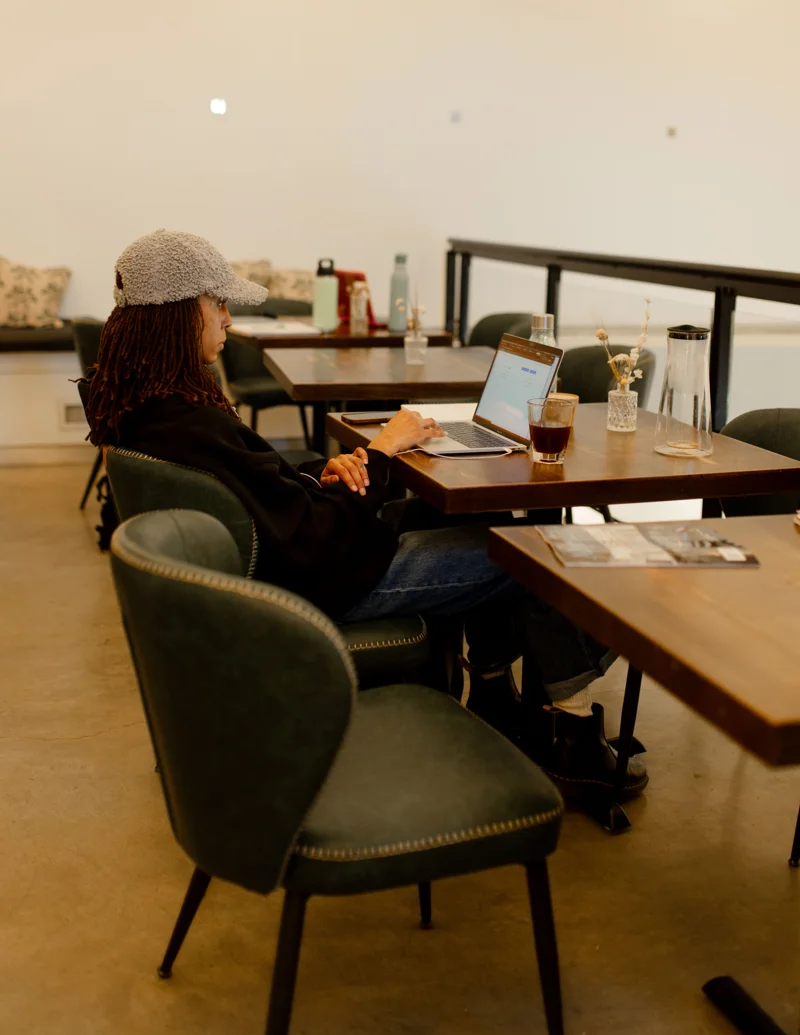 A guest with a laptop at an upstairs table