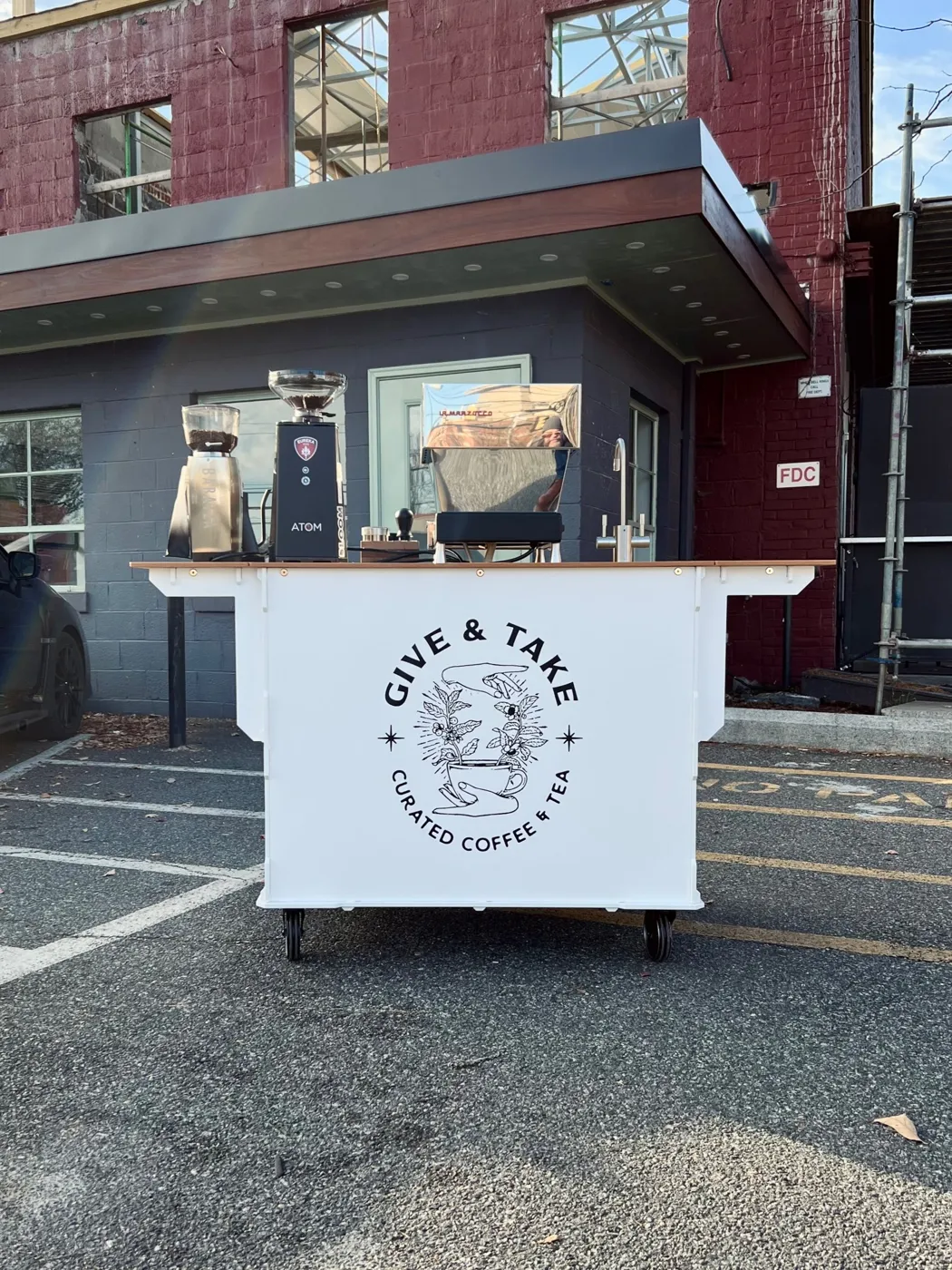 The original Give & Take coffee cart outside the purple building